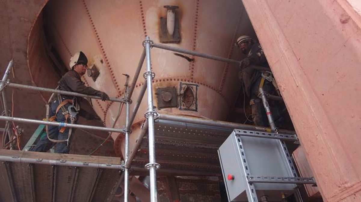 Contractors installing the pipe nozzles at a  30º angle to promote material flow.